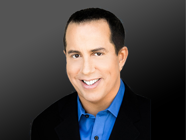 paul-adamon-blog-headshot headshot of Paul Scott Adamo wearing a blue shirt with a black jacket against a dark background